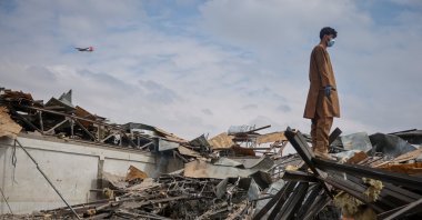 A man stands on the debris at the site of a drug rehabilitation hospital destroyed in what the Taliban said was a Pakistani airstrike in Kabul, Afghanistan, March 17, 2026. (Reuters Photo)