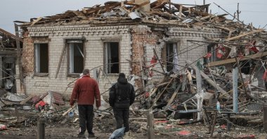 Residents stand at the site of a Russian missile strike, amid Russia's attack on Ukraine, village of Zaitseve, Dnipropetrovsk region, Ukraine, March 16, 2026. (Reuters Photo)