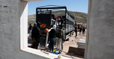 Members of a Palestinian Bedouin community prepare to leave following Israeli settler violence, in Al Mughayyir, near Ramallah, in the Israeli-occupied West Bank, Palestine, Feb. 21, 2026. (Reuters Photo)