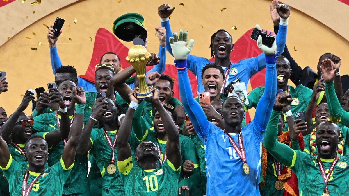 Senegal's Sadio Mane holds up the trophy as he celebrates with his teammates after winning the Africa Cup of Nations (AFCON) final football match against Morocco at the Prince Moulay Abdellah Stadium, Rabat, Morocco, Jan. 18, 2026. (AFP Photo)