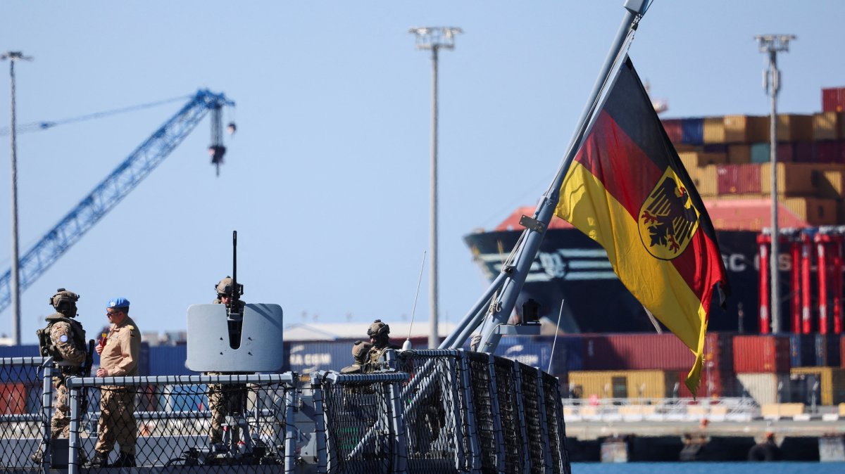 Military personnel stand next to a German flag with a coat of arms, on board the German frigate FGS Nordrhein-Westfalen as it arrives at the port of Limassol, amid the conflict in the Middle East, Limassol, Greek Cyprus, March 8, 2026. (Reuters Photo)