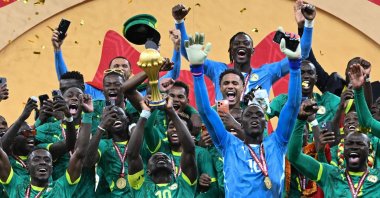 Senegal's Sadio Mane holds up the trophy as he celebrates with his teammates after winning the Africa Cup of Nations (AFCON) final football match against Morocco at the Prince Moulay Abdellah Stadium, Rabat, Morocco, Jan. 18, 2026. (AFP Photo)