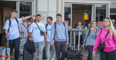 Tourists are seen exiting the Antalya Airport in this file photo released on March 7, 2026. (DHA Photo)