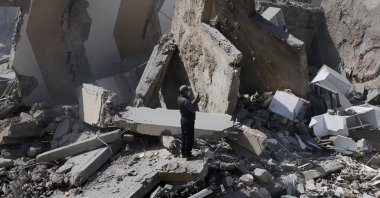 A man uses a phone while standing amid debris at the site of an Israeli strike, Zuqaq al-Blat district in central Beirut, Lebanon, March 18, 2026. (Reuters Photo)