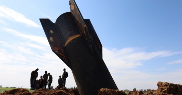 People stand next to an Iranian missile launched in retaliation against U.S. bases in nearby countries, the village of Qazaljo, Qamishli countryside, Syria, March 4, 2026.