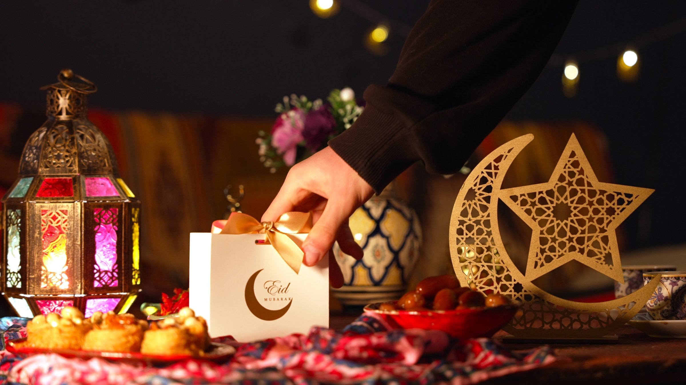 A festive Eid table adorned with treats and wrapped gifts. (Shutterstock Photo)