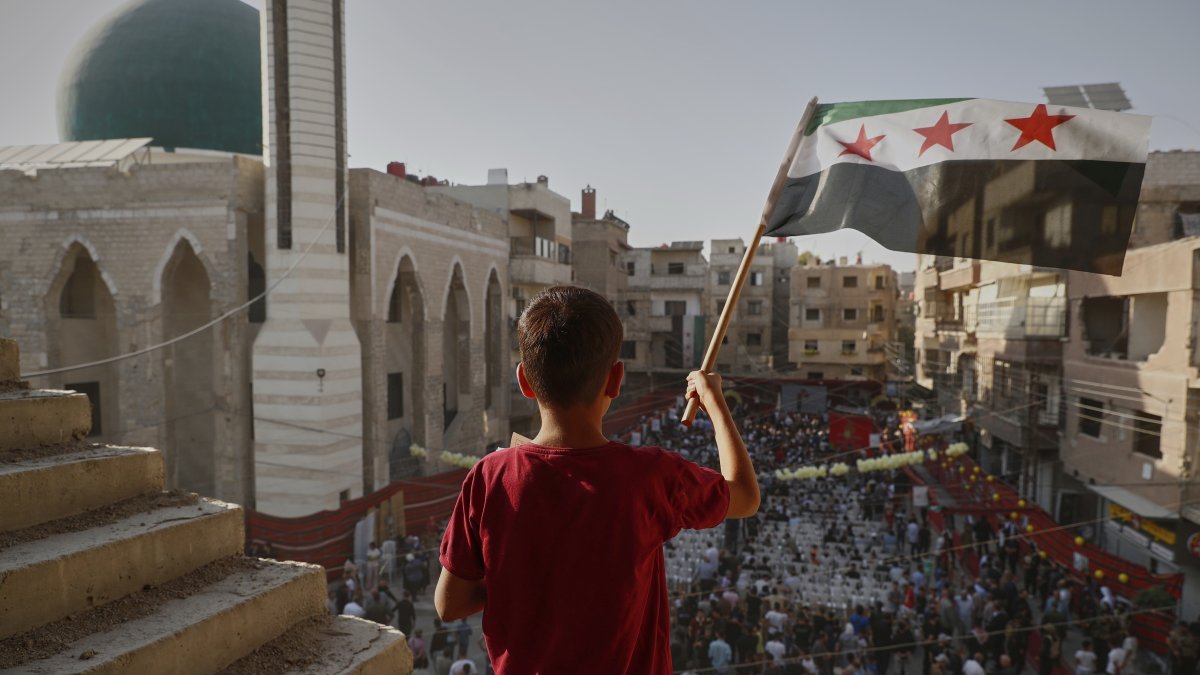 Syrians gather to mark the anniversary of a chemical weapons attack carried out by Bashar Assad's forces in Eastern Ghouta in 2013, in the town of Zamalka, on the outskirts of Damascus, Syria, Aug. 21, 2025. (AP Photo)