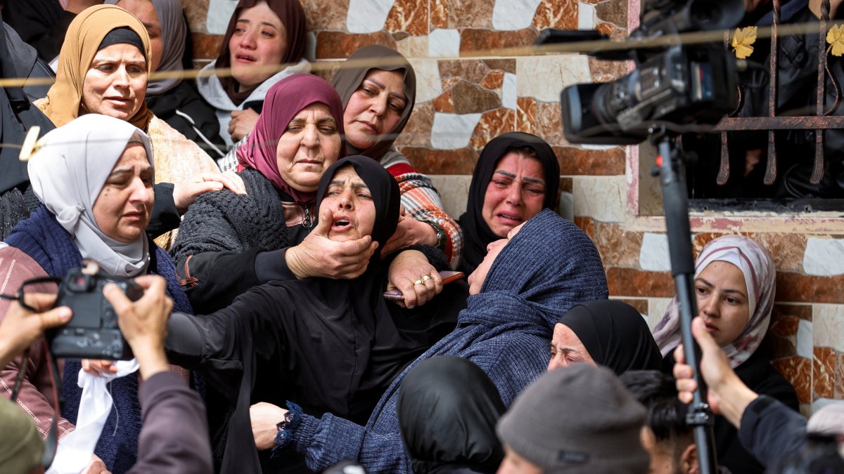 Mourners react during the funeral of Palestinian women who were killed in an Iranian missile attack, in Beit Awwa, near Hebron, in the Israeli-occupied West Bank, Palestine, March 19, 2026. (Reuters Photo)