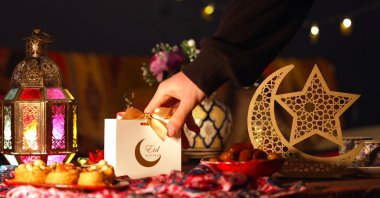 A festive Eid table adorned with treats and wrapped gifts. (Shutterstock Photo)