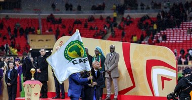 CAF President Patrice Motsepe hands the CAF flag to representatives of Kenya, Tanzania, and Uganda, the next AFCON hosts, during the Africa Cup of Nations final between Senegal and Morocco at Prince Moulay Abdellah Stadium, Rabat, Morocco, Jan. 18, 2026. (Getty Images Photo)