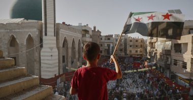 Syrians gather to mark the anniversary of a chemical weapons attack carried out by Bashar Assad's forces in Eastern Ghouta in 2013, in the town of Zamalka, on the outskirts of Damascus, Syria, Aug. 21, 2025. (AP Photo)
