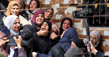 Mourners react during the funeral of Palestinian women who were killed in an Iranian missile attack, in Beit Awwa, near Hebron, in the Israeli-occupied West Bank, Palestine, March 19, 2026. (Reuters Photo)