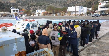 Migrants stand in line as a Greek coast guard officer counts them at the port of Kaloi Limenes, on the island of Crete, Greece, Feb. 21, 2026. (Reuters Photo)