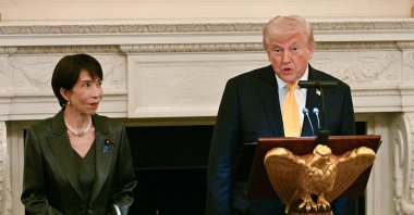 US President Donald Trump (R) speaks with Japan's Prime Minister Sanae Takaichi standing next to him at a dinner in the State Dining Room of the White House, Washington, U.S., March 19, 2026. (AFP Photo)
