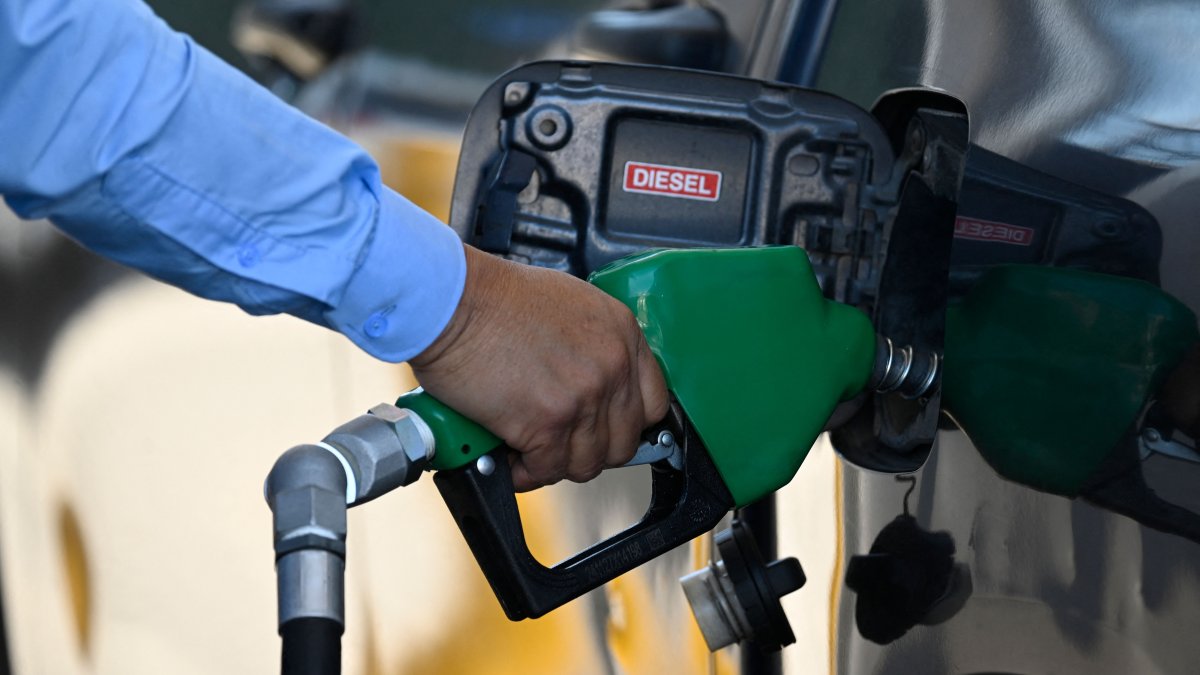 A man holds a fuel pump at a gas station in Guatemala City, Guatemala, March 10, 2026. (AFP Photo)