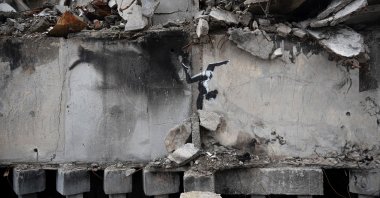 A painting by British street artist Banksy is seen on a building destroyed by fighting in Borodyanka, Kyiv region, Ukraine, Nov. 13, 2022. (AP Photo)