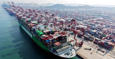 A cargo ship and containers are seen at a port in Qingdao, China, March 10, 2026. (AFP Photo)