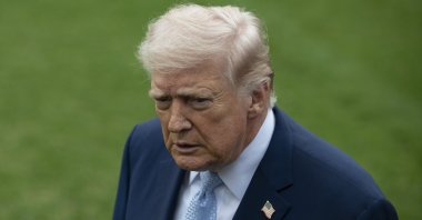 Donald Trump responds to a question from the news media as he walks to board Marine One on the South Lawn of the White House in Washington, D.C., U.S., March 20, 2026. (AA Photo) 