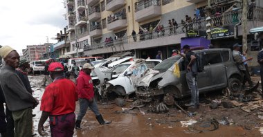 People clean the street after floods, Nairobi, Kenya, March 7, 2026. (DHA Photo)
