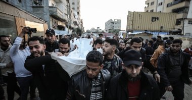 Family and friends carry the body of a Palestinian who was killed during an Israeli missile strike, Gaza City, Palestine, March 22, 2026. (AA Photo)