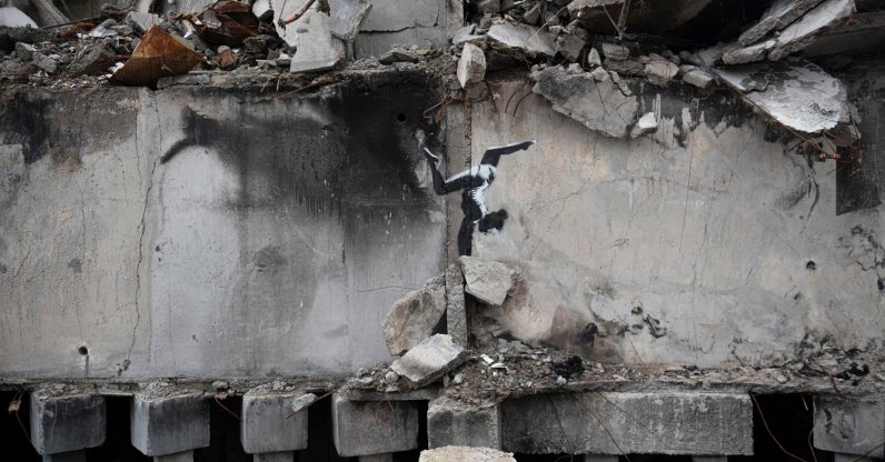 A painting by British street artist Banksy is seen on a building destroyed by fighting in Borodyanka, Kyiv region, Ukraine, Nov. 13, 2022. (AP Photo)