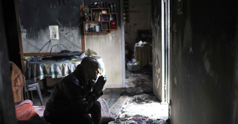 A Palestinian man sits in what remains of his burnt-out family home following a reported attack by Israeli settlers in the village of Fandaqumiya, southwest of Jenin, in the Israeli-occupied West Bank, Palestine, March 22, 2026. (AFP Photo)