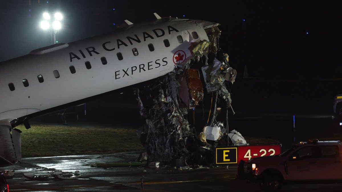 An Air Canada Express CRJ-900 sits on the runway after colliding with a Port Authority fire truck at LaGuardia Airport in New York, U.S., March 23, 2026. (AFP Photo)