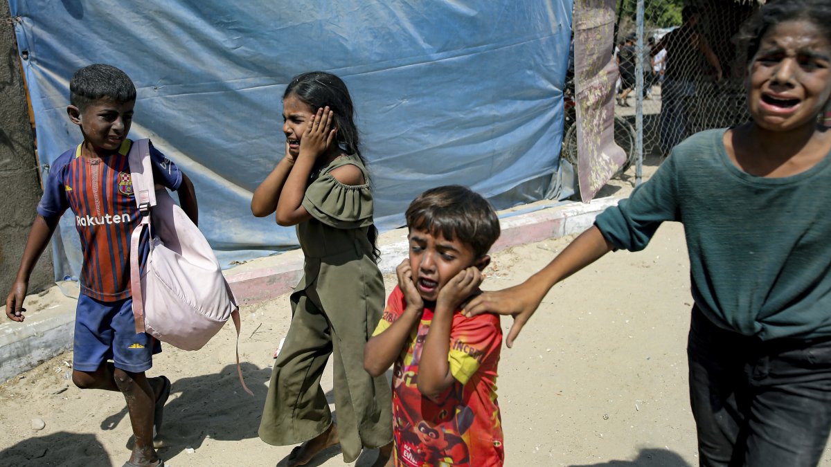 This file photo shows Palestinian children being evacuated from a site targeted by an Israeli bombardment on Khan Younis, southern Gaza Strip, July 13, 2024. (AP Photo)