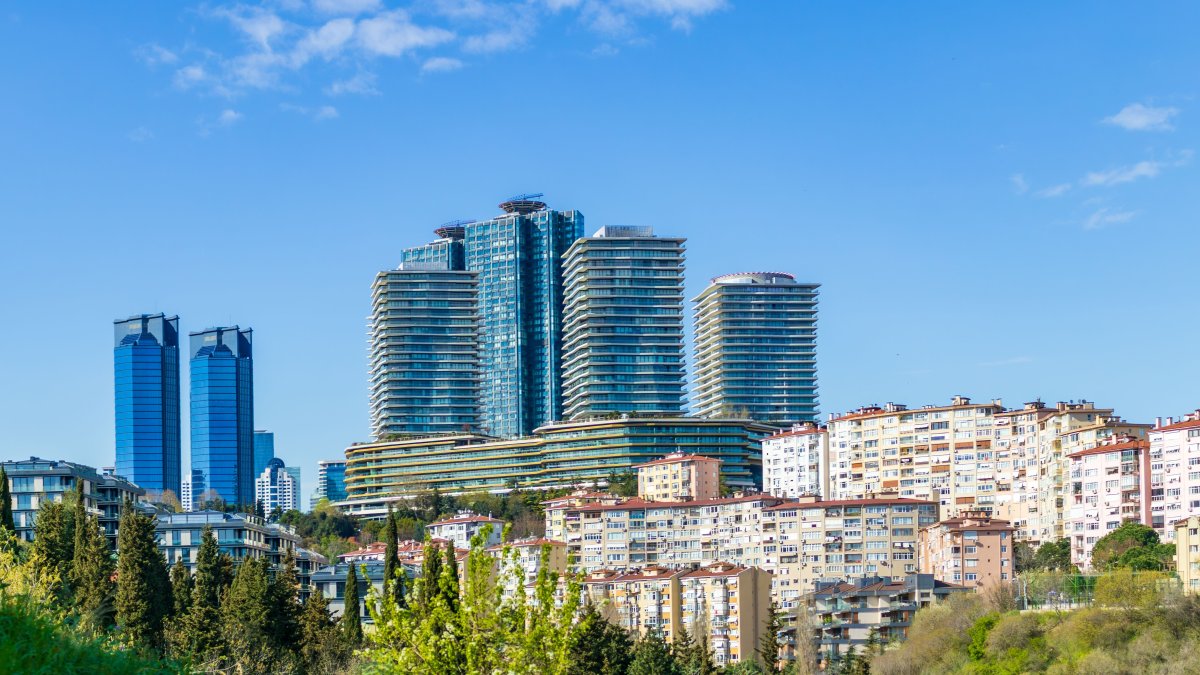 Modern residential and business towers rise above traditional housing in Istanbul, Türkiye, March 31, 2025. (Shutterstock Photo) 