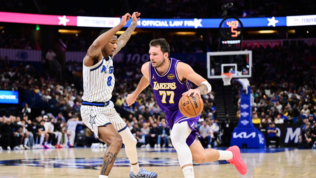 Los Angeles Lakers guard Luka Doncic (R) drives to the basket against Orlando Magic forward Jamal Cain during the first half at Kia Center, Orlando, U.S., March 21, 2026. (AFP Photo)
