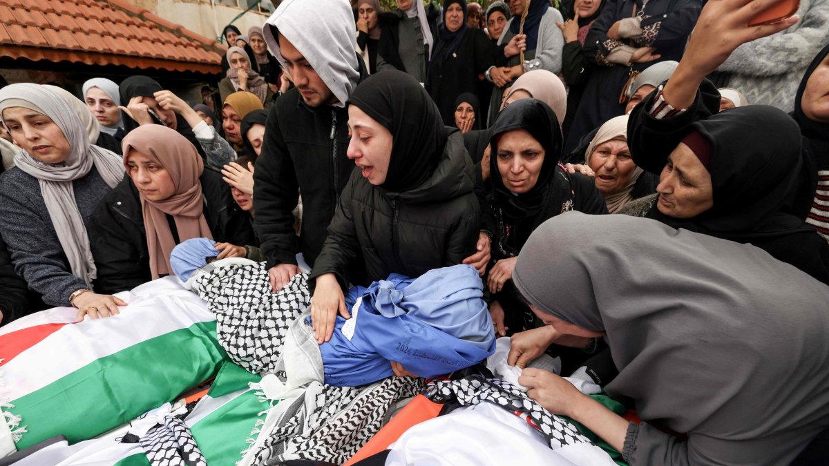 Family members grieve over the bodies of four members of a Palestinian family, including two children, killed by Israeli soldiers in their vehicle, during their funeral in the Israeli-occupied West Bank's northern town of Tammun, March 15, 2026. (AFP Photo)