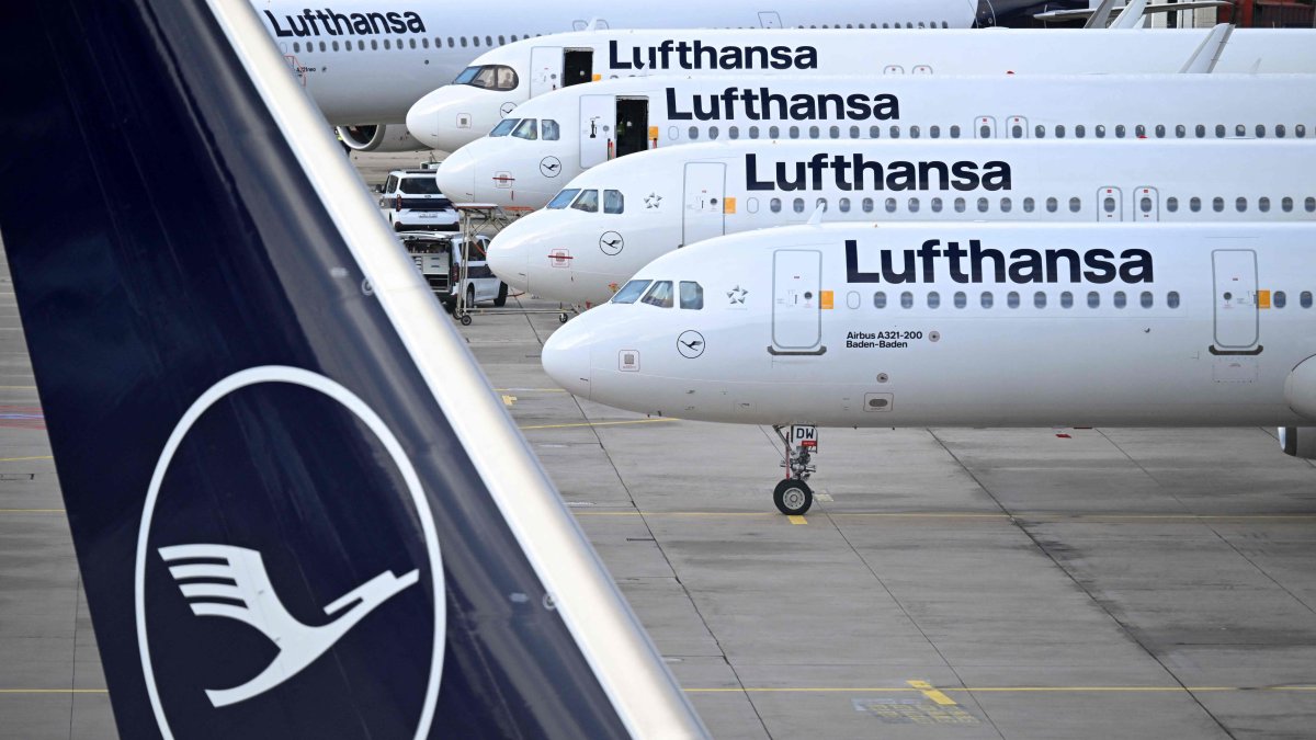 The logo of German airline Lufthansa is seen on the vertical stabiliser and aircraft parked on the tarmac at the international Frankfurt Airport, Frankfurt am Main, western Germany, March 12, 2026. (AFP File Photo)