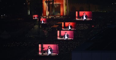BTS fans watch the comeback concert of K-pop boy group BTS on screens at the venue in Seoul, South Korea, March 21, 2026. (AFP Photo)