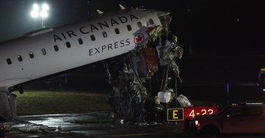 An Air Canada Express CRJ-900 sits on the runway after colliding with a Port Authority fire truck at LaGuardia Airport in New York, U.S., March 23, 2026. (AFP Photo)