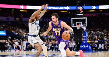 Los Angeles Lakers guard Luka Doncic (R) drives to the basket against Orlando Magic forward Jamal Cain during the first half at Kia Center, Orlando, U.S., March 21, 2026. (AFP Photo)
