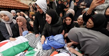 Family members grieve over the bodies of four members of a Palestinian family, including two children, killed by Israeli soldiers in their vehicle, during their funeral in the Israeli-occupied West Bank's northern town of Tammun, March 15, 2026. (AFP Photo)