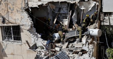 Israeli soldiers inspect the site of a damaged building following barrages of Iranian missiles, amid the U.S.-Israeli conflict with Iran, in Tel Aviv, Israel, March 22, 2026. (Reuters Photo)