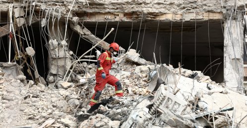 Emergency personnel work at the site of a strike on a residential building, amid the U.S.-Israeli conflict with Iran, in Tehran, Iran, March 23, 2026. (Reuters Photo)