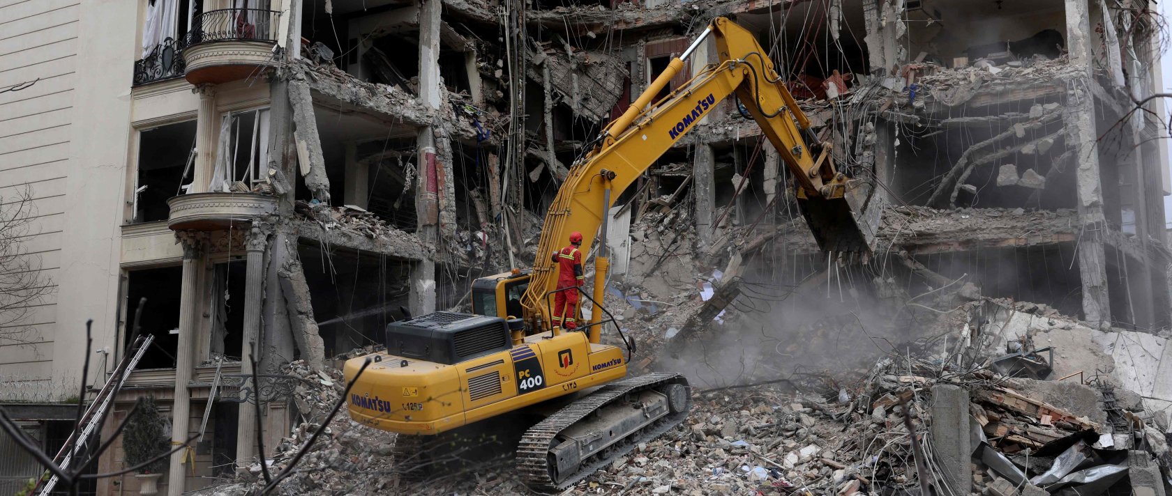 Iranian firefighters use an excavator to clear rubble from a residential building destroyed by an Israeli airstrike, Tehran, Iran, March 23, 2026. (AFP Photo)