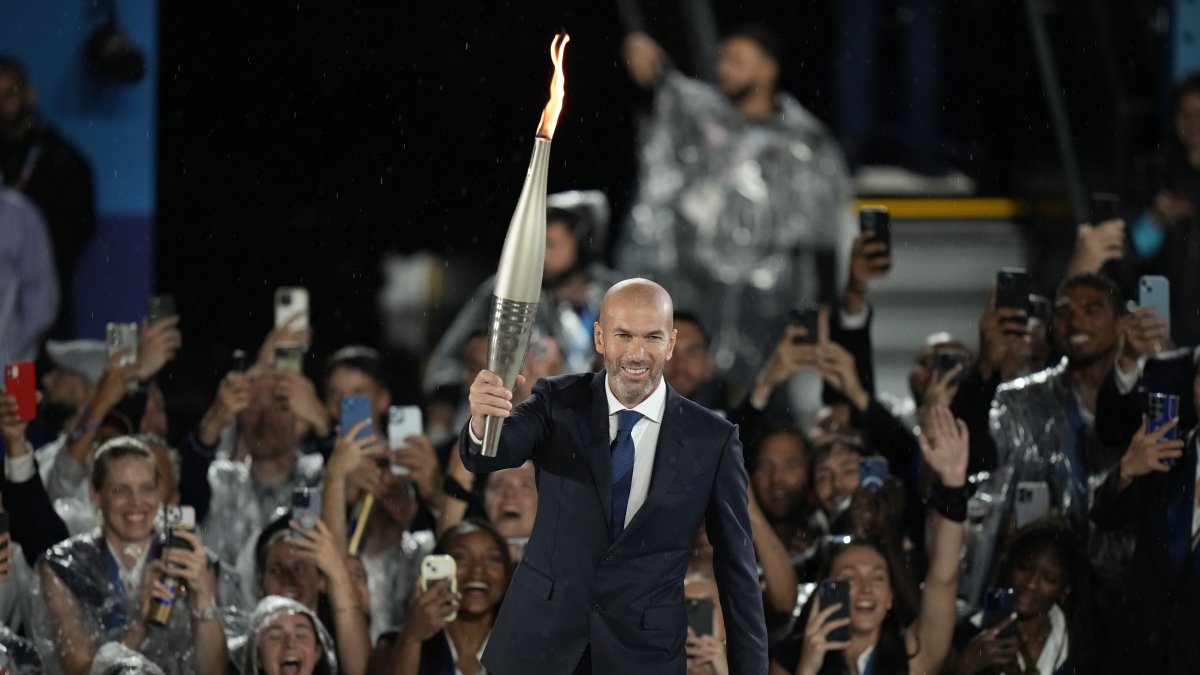Zinedine Zidane carries the torch during the opening ceremony of the 2024 Summer Olympics, Paris, France, July 26, 2024. (AP Photo)