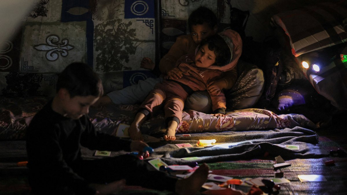Children rest in a tent, inside the Camille Chamoun Stadium, which is used as a temporary encampment for displaced people, following Israeli attacks on Beirut, Lebanon, March 22, 2026. (Reuters Photo)