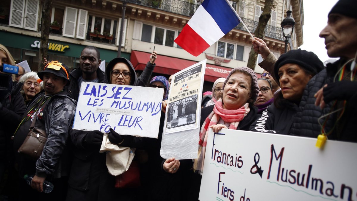 Protestors hold placards during a demonstration against Islamophobia, in Paris, France, Nov. 10, 2019. (AP File Photo)