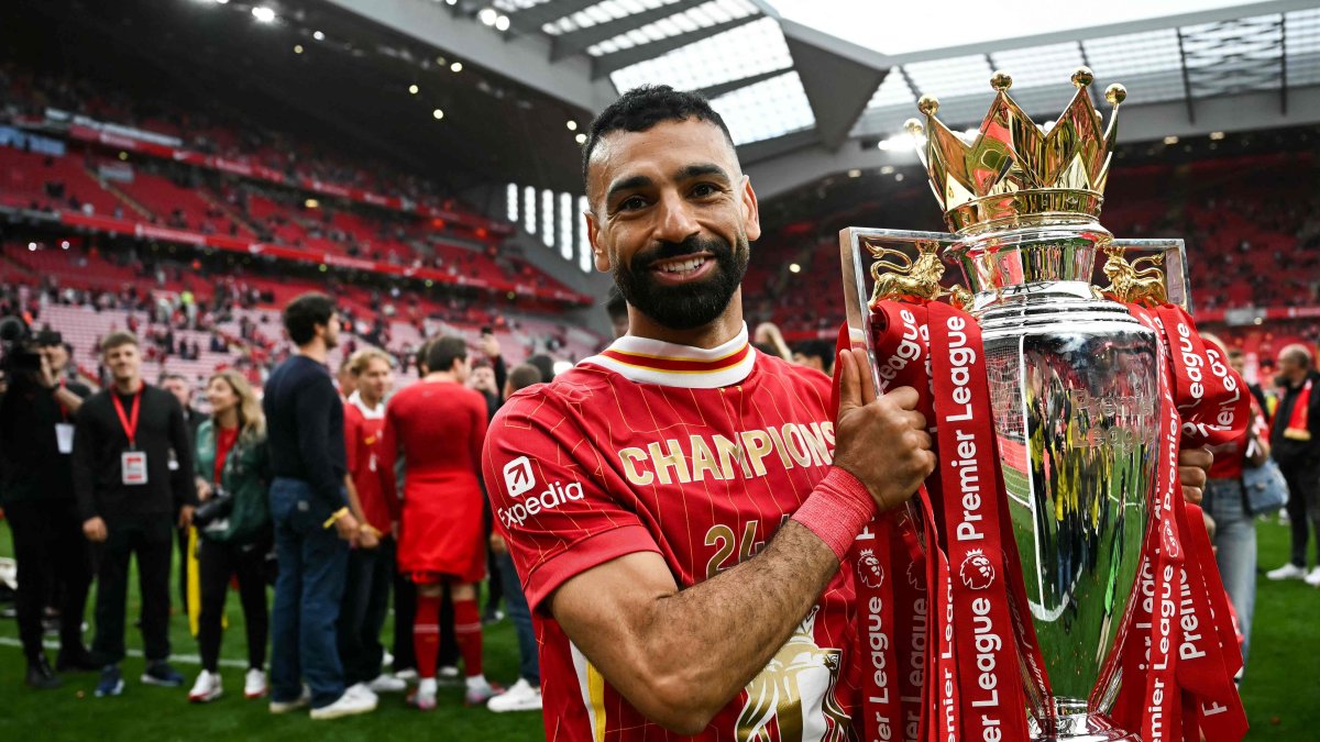 Liverpool's Egyptian striker #11 Mohamed Salah celebrates with the Premier League trophy at the end of the English Premier League football match between Liverpool and Crystal Palace at Anfield in Liverpool, north west England, May 25, 2025. (AFP File Photo)