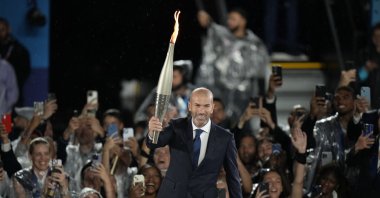 Zinedine Zidane carries the torch during the opening ceremony of the 2024 Summer Olympics, Paris, France, July 26, 2024. (AP Photo)