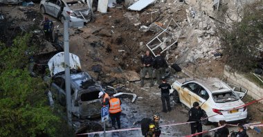 Israeli emergency service personnel gather at the site of an Iranian missile strike in Tel Aviv, Israel, March 24, 2026. (AFP Photo)