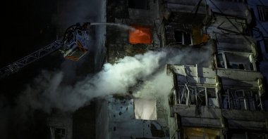 Firefighters work at the site of an apartment building hit by a Russian drone strike in Zaporizhzhia, Ukraine, March 24, 2026. (Reuters Photo)
