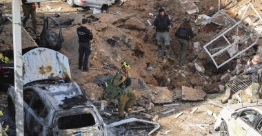 Israeli emergency service personnel gather at the site of an Iranian missile strike in Tel Aviv, Israel, March 24, 2026. (AFP Photo)