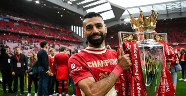 Liverpool's Egyptian striker #11 Mohamed Salah celebrates with the Premier League trophy at the end of the English Premier League football match between Liverpool and Crystal Palace at Anfield in Liverpool, north west England, May 25, 2025. (AFP File Photo)