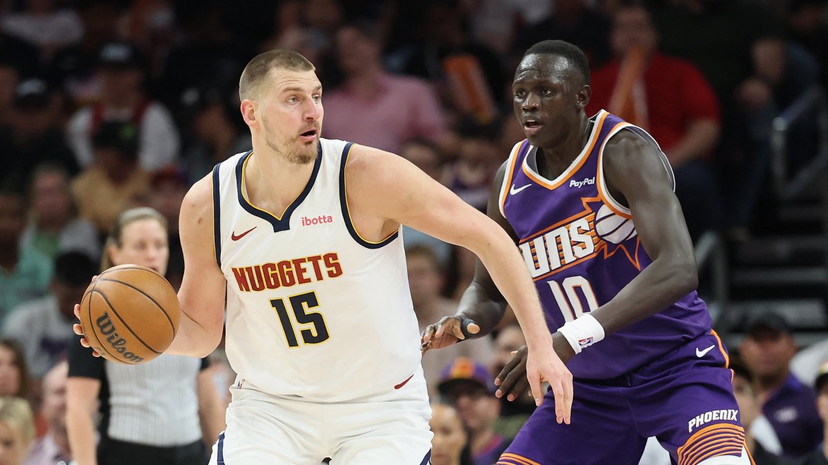 Denver Nuggets' Nikola Jokic handles the ball against Phoenix Suns' Khaman Maluach during the first half of the NBA game at Mortgage Matchup Center, Phoenix, U.S., March 24, 2026. (AFP Photo)
