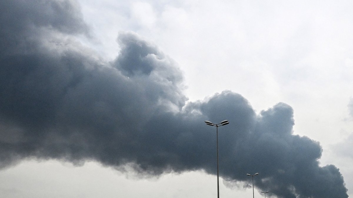 Smoke rises from the area of the Kuwait International Airport after a reported drone strike hit a fuel depot on March 25, 2026. (AFP Photo)